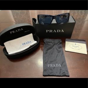 Prada sunglasses: Dark blue frames& lenses.